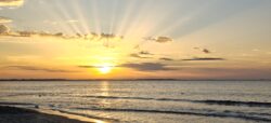 Panoramic golden sunset with sun rays over the Baltic Sea